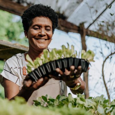 A woman with plants in her hands, Source: iStock